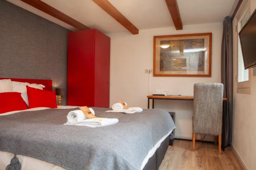 a bedroom with a bed with towels on it at Kings Inn City Hotel Alkmaar in Alkmaar