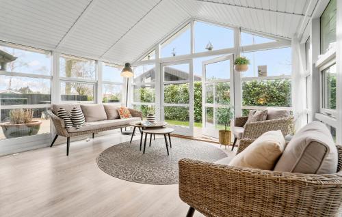 a living room with a lot of windows at 2 Bedroom Nice Home In Juelsminde in Juelsminde