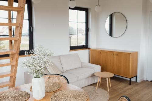 a living room with a couch and a table at Przystanek na Podhalu in Długopole