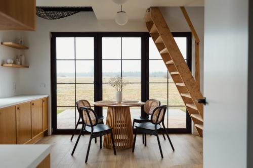 a kitchen and dining room with a table and chairs at Przystanek na Podhalu in Długopole