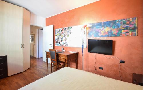 a bedroom with a desk and a tv on a wall at Awesome Home In Bergamo With Wifi in Bergamo