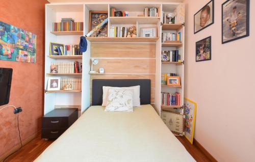 a small bedroom with a bed and bookshelves at Awesome Home In Bergamo With Wifi in Bergamo