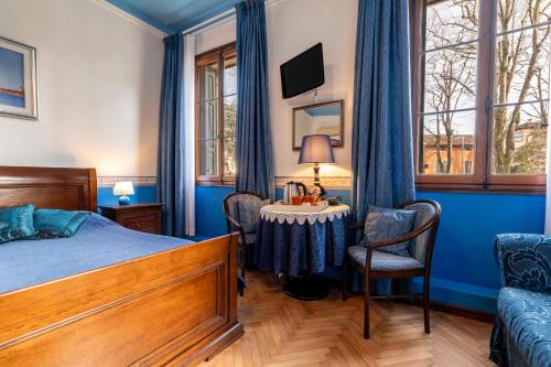 a bedroom with a bed and a table and chairs at B&B Casa delle Rose in Venice-Lido