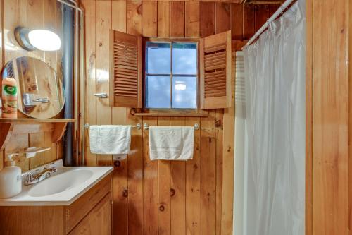 a bathroom with a sink and a window and a shower at Cozy Laconia Studio with Pool Access - 2 Mi to Lake! in Laconia