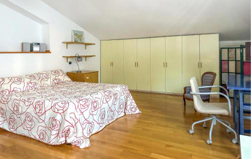 a bedroom with a bed and a desk and a chair at Cozy Home In Pescara With Wifi in Pescara