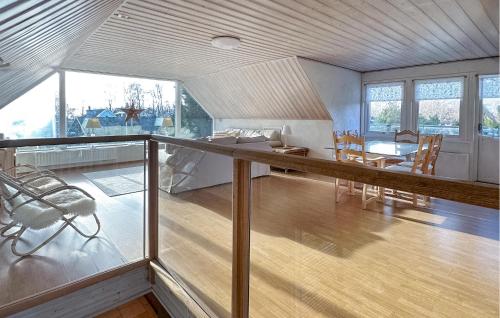 a living room with a table and chairs and a dining room at Lovely Home In Nybrostrand With Sauna in Glemminge