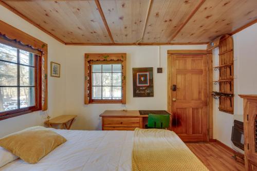 a bedroom with a bed and a wooden ceiling at Quiet Laconia Studio, Near Mill Falls Marketplace! in Laconia