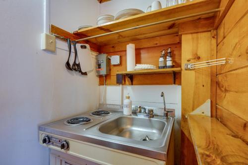 a kitchen with a sink and a stove at Quiet Laconia Studio, Near Mill Falls Marketplace! in Laconia