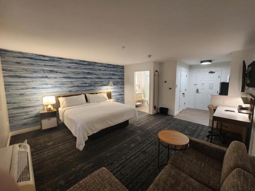 a bedroom with a large bed with a painting on the wall at TownePlace Suites by Marriott Killeen in Killeen