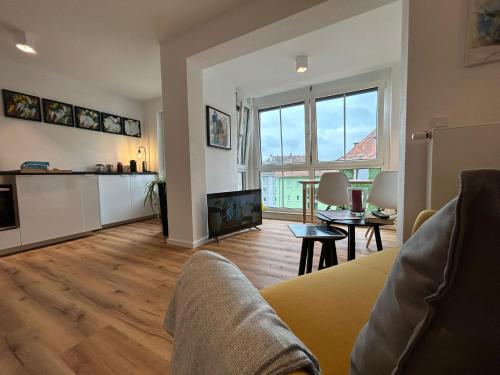 a living room with a couch and a fireplace at City Apartment mit TG Stellplatz - Glücks-Quartier Urban 01 in Pforzheim