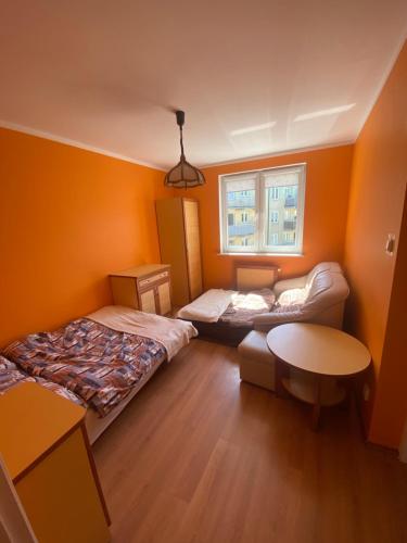 a small room with two beds and a table at Apartament „Na wydmie” in Ustka