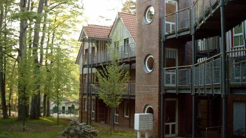 a brick building with a clock on the side of it at Seeblick Wohnung 215 in Ostseebad Koserow