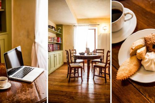 a kitchen and a dining room with a table with a laptop at Da Gin in Castelbianco