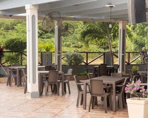 a restaurant with tables and chairs on a patio at Hotel el barco in Azua de Compostela