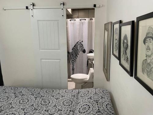 a bathroom with a zebra standing in the shower at Zebra Studio in Tijuana