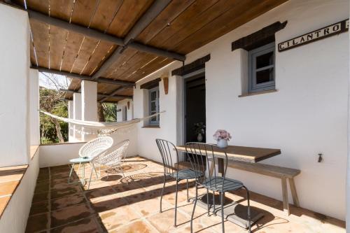 a patio with a table and chairs on it at Posada Morisca Charming Hotel Boutique in Frigiliana