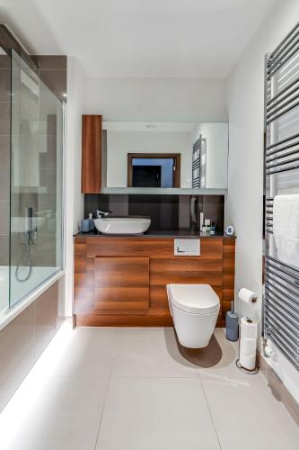 a bathroom with a toilet and a sink at Stylish flat in Peterborough in Peterborough