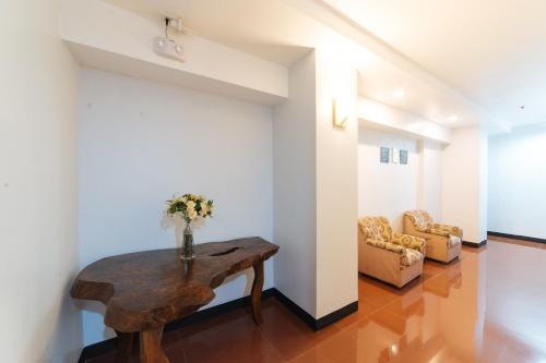 a living room with a table and a couch at RedDoorz at Nirvana Pension House in Bacolod