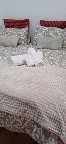 a bed with white sheets and pillows on it at Casina 31 in Città di Castello