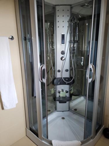 a shower stall with a sink in a bathroom at Party House 