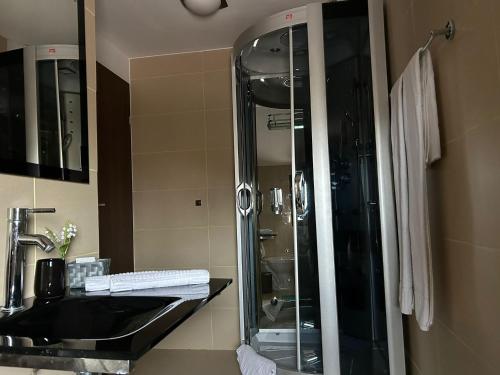 a bathroom with a glass shower and a sink at Party House 