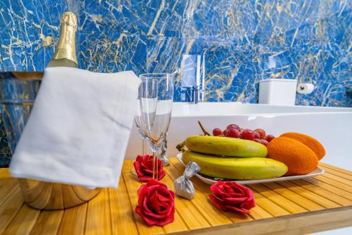 a table with a plate of fruit and a bottle of champagne at CASA DE LA SEÑORA in Palma del Río