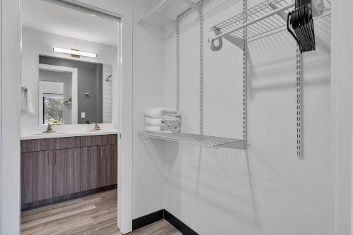 a bathroom with a shower with a sink and a mirror at The Well #209 Apartment in Zephyrhills