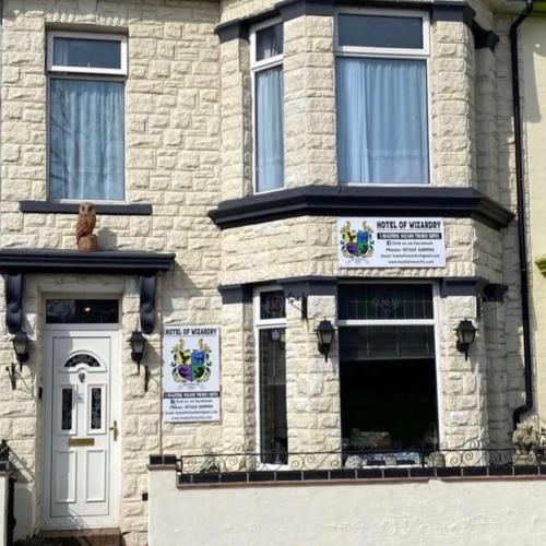 a building with a teddy bear sitting on the front porch at Hotel Of Wizardry in Great Yarmouth