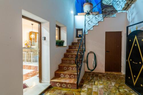 a staircase in a home with a blue ceiling at CASA DE LA SEÑORA in Palma del Río