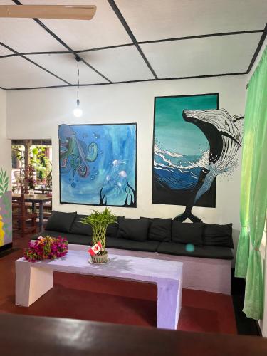 a living room with a couch and a painting at Lobster Inn in Trincomalee