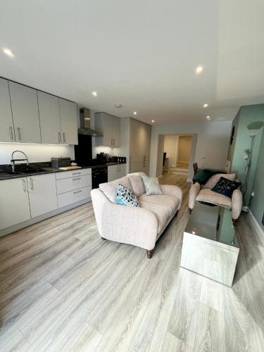a living room with a couch and a kitchen at Mary McGill’s in Ballycastle