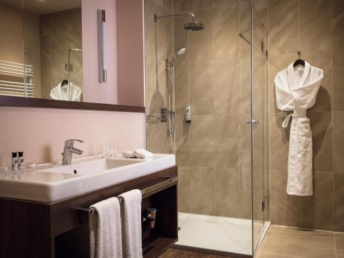 a bathroom with a sink and a shower at ABION Villa Suites in Berlin