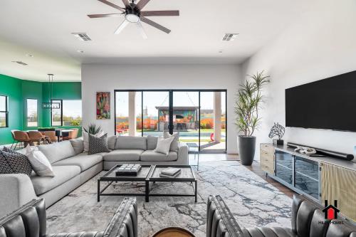 a living room with a couch and a tv at Peaceful Getaway to a New Custom-Built Luxury Home in Rio Verde