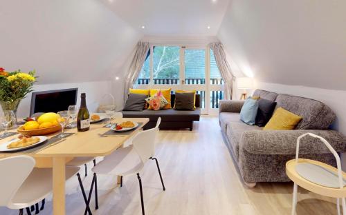 a living room with a table and a couch at St Ives Bluebell Cottage in St Ives
