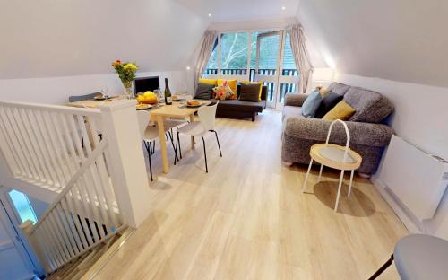 a living room with a couch and a table at St Ives Bluebell Cottage in St Ives