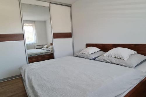a bedroom with a large bed with a large mirror at Alpenpanorama Oase in Feldkirch