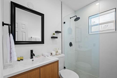 a bathroom with a toilet and a glass shower at Spacious 2 BR @Sailboat Bend in Fort Lauderdale