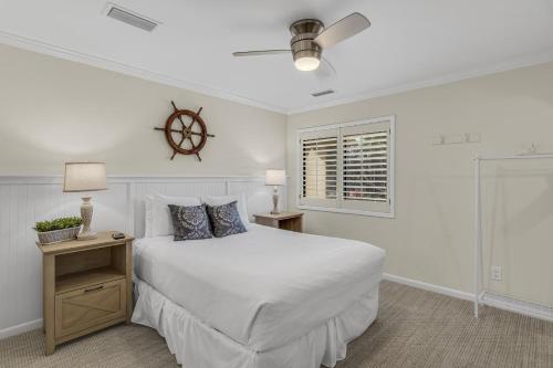 a white bedroom with a large bed and a window at Beachwalk Villa 5140 in Destin