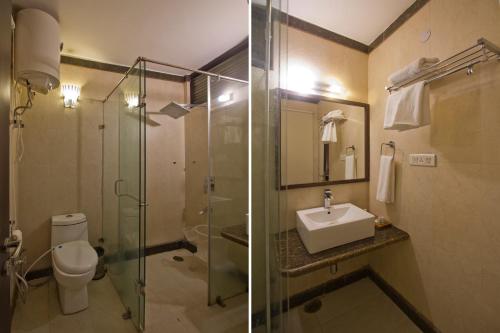 a bathroom with a shower and a toilet and a sink at The Whispering Inn Resort and Bar (An Exotic Vintage Beauty ) in Manāli