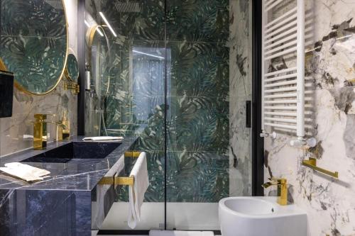 a bathroom with a shower and a sink and a toilet at Maison 31 -Luxury Apartments in Santa Marinella