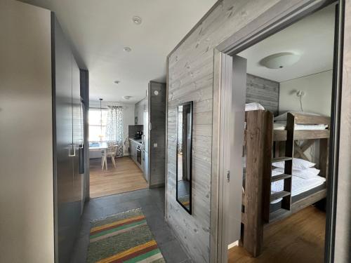 a small room with a bunk bed and a hallway at Funäsdalshöjden Funäsdalen in Funäsdalen