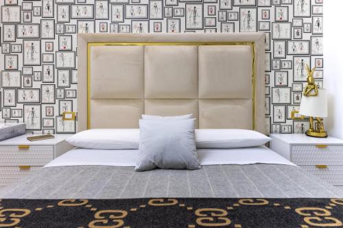 a bedroom with a bed and a wall of pictures at Maison 31 -Luxury Apartments in Santa Marinella