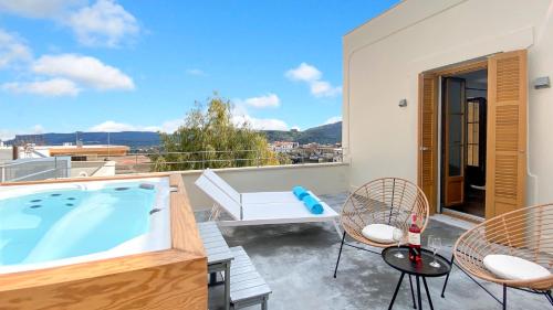 a hot tub on the balcony of a house at Sun Stone Villas in Chania Town