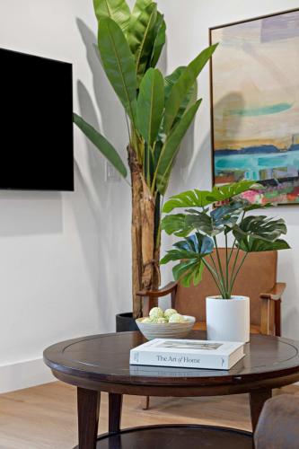 a coffee table with a book and a plant at Awesome 1BR Apartment @Sailboat in Fort Lauderdale