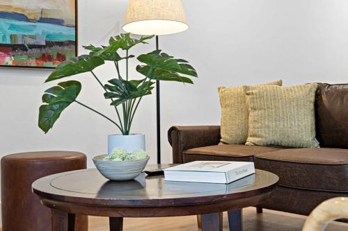 a living room with a table with a book and a plant at Awesome 1BR Apartment @Sailboat in Fort Lauderdale