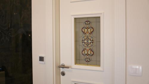 a door with a stained glass window on it at Grand Hotel Belushi in Boge