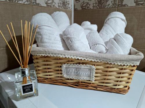 a basket of towels on a table in a bathroom at Ego Residence Alba Iulia in Alba Iulia