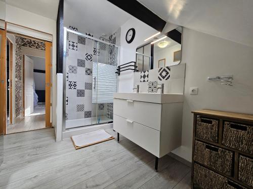 a bathroom with a sink and a shower at Le Doux Repos in Étretat