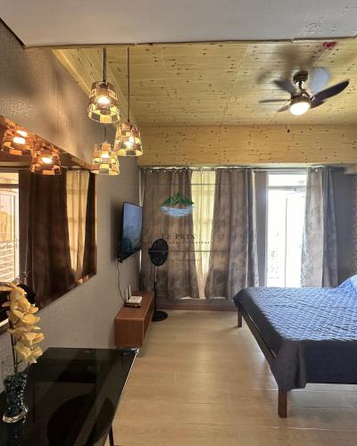 a bedroom with a bed and a ceiling fan at Twin Lakes Tagaytay - Le Prin in Tagaytay