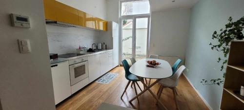 a kitchen with a table and chairs in a room at Bruxelles ma belge in Brussels